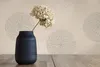 A dark blue vase with dried flowers sits on a wooden table in front of a patterned wallpaper. Produktbild-Vorschau