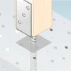 A close-up illustration of a post anchor securing a wooden post to a concrete surface. Náhľad obrázku produktu