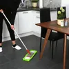 A person is mopping the floor in a modern kitchen/dining area. Produktbild-Vorschau