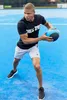 A man is exercising with a medicine ball on a blue court. Náhľad obrázku produktu