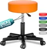 An orange adjustable rolling stool with a black base and wheels, shown on a white background. Several other colored stool tops are displayed to the right. Produktbild-Vorschau