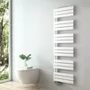 A modern bathroom with a wall-mounted toilet, a plant, and a white designer radiator. Podgląd zdjęcia produktu
