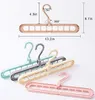 A set of multi-functional hangers in different colors, with measurement annotations. Produktbild-Vorschau