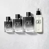Four bottles of Giorgio Armani Acqua di Gio perfume are arranged on a light gray and white textured surface. Anteprima dell’immagine prodotto