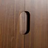 A close-up view of a wooden sideboard with an integrated handle. Produktbild-Vorschau