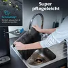 A person is rinsing a black mat under a kitchen faucet. The mat appears to be a non-slip mat. Produktbild-Vorschau