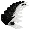 A set of black straps with white plastic clips, arranged diagonally on a white background. Produktbild-Vorschau
