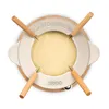 A fondue set with melted cheese inside, viewed from directly above. Voir les images du produit