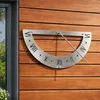 A sundial mounted on a wooden wall. Produktbild-Vorschau