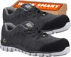 A pair of dark gray work shoes with black toe caps and soles, displayed in front of a cardboard box with the brand name. Produktbild-Vorschau