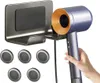 A hand holding a blue hair dryer next to a gray wall-mounted holder, with five circular magnetic nozzle holders below. Produktbild-Vorschau
