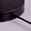 A close-up view of a black metallic object with a cable entering it. Produktbild-Vorschau