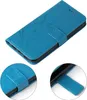 A blue flip cover phone case with a floral embossed pattern. Produktbild-Vorschau