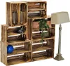 A set of wooden crates arranged as shelving, with a lamp and decorative items. Anteprima dell’immagine prodotto