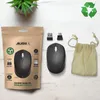 A wireless mouse, its packaging, and accessories are laid out on a white wooden surface, with a small potted plant in the background. Anteprima dell’immagine prodotto