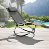 A rocking lounge chair is placed on a wooden deck next to a swimming pool with a scenic mountain backdrop. Produktbild-Vorschau