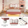 A child's bed with a bow-shaped headboard, shown in a bedroom setting with a desk and chair, and close-up views of the bed's features. Produktbild-Vorschau