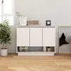 A white sideboard with three doors and an open shelf below, placed in a room with a window and a plant. Náhľad obrázku produktu
