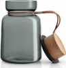 A glass storage jar with a wooden lid and a leather strap. Náhled obrázku produktu