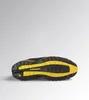 The sole of a black and yellow Diadora utility shoe is shown against a light gray background. Náhľad obrázku produktu