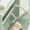 Close-up of a green shoe cabinet with a white plastic tilting mechanism and a beige shoe. Produktbild-Vorschau