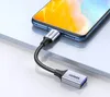 A close-up shot of a Ugreen USB-C to USB-A OTG adapter cable connected to a smartphone. Podgląd zdjęcia produktu