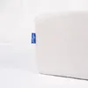 A close-up of a white fabric product with a blue tag attached to the side. Produktbild-Vorschau