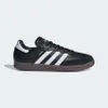 A studio shot of a black Adidas Samba sneaker with white stripes and a brown sole. Náhled obrázku produktu