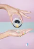 Two hands are shown, one holding a pill dispenser over the other, which is open to catch pills. Produktbild-Vorschau