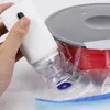 A hand holds a white electric vacuum pump over a sealed plastic bag containing a spool of red filament and a grey spool lid. Náhľad obrázku produktu