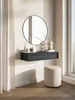 A minimalist entryway or dressing area with a floating console, a round mirror, and a stool. Náhľad obrázku produktu
