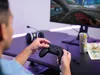 A person playing a video game on a computer with a controller. Náhled obrázku produktu