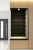 A modern entryway with a built-in bench and padded wall panels. Produktbild-Vorschau