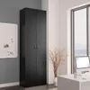 A tall, black storage cabinet stands in a room next to a whiteboard and a large window. A desk with a computer is visible in the foreground. Produktbild-Vorschau