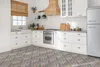 A modern kitchen with white cabinets, a wooden range hood, and a patterned tile floor. Produktbild-Vorschau