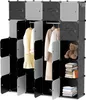 A modular storage unit with multiple compartments, some open and some closed, displaying clothing, books, and a teddy bear. Produktbild-Vorschau
