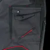 A close-up view of a dark gray work pant pocket with red stitching and branding. Produktbild-Vorschau