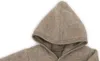 A close-up view of a hooded garment. Produktbild-Vorschau