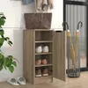 A shoe cabinet with shoes and slippers in a hallway setting. Anteprima dell’immagine prodotto