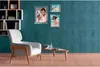 A living room scene with a chair, coffee table, and framed pictures on the wall. Náhľad obrázku produktu