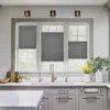 A kitchen sink area with a window above, featuring gray pleated blinds. Produktbild-Vorschau