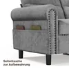Close-up of the side of a gray sofa, showing a side pocket with two books inserted. Produktbild-Vorschau