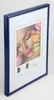 A framed picture of macarons and a woman's face with colorful makeup. Produktbild-Vorschau