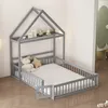 A grey wooden children's house bed with a mattress and safety rails, set up in a room with white striped wallpaper and a hint of a green closet in the background. Náhľad obrázku produktu