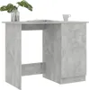 A gray concrete-effect desk with a drawer and a cabinet door. A plant in a glass vase and a book are on the desktop. Podgląd zdjęcia produktu