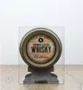 A miniature barrel of blended scotch whisky displayed in a clear plastic case on a wooden surface. Produktbild-Vorschau