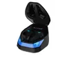 A pair of black wireless earbuds in an open charging case with blue LED lighting. Produktbild-Vorschau