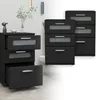 A set of black nightstands with frosted glass drawer fronts, displayed in a room setting with a wall and floor. Produktbild-Vorschau