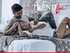 A couple is lying on a bed, cuddling. Produktbild-Vorschau