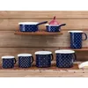A collection of blue enamel cookware with white polka dots and stars, arranged on wooden shelves against a wooden plank background. Produktbild-Vorschau